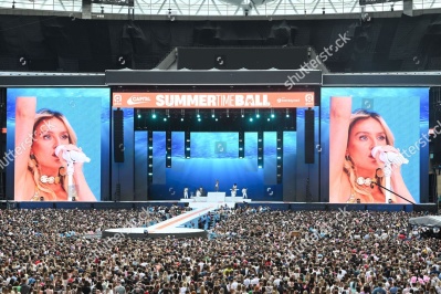 https___www_shutterstock_com_editorial_image-editorial_M6TeQ72bN3zdg838Mjc5NDg3D_perrie-performing-on-stage-capital_s-summertime-ball-1500w-14539554ju.jpg