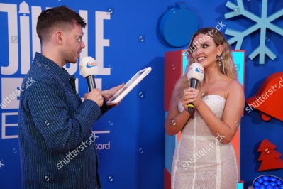 https___www_shutterstock_com_editorial_image-editorial_M8TdU3x4Mcj1I430Njg1Mjk3D_perrie-talks-alex-oxlaide-chamberlain-on-tablet-backstage-1500w-14977322dn.jpg