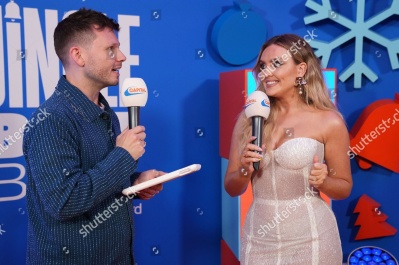 https___www_shutterstock_com_editorial_image-editorial_M1T5U1x7Mbj0I739Njg1NDE3D_perrie-talks-alex-oxlaide-chamberlain-on-tablet-backstage-1500w-14977322dr.jpg